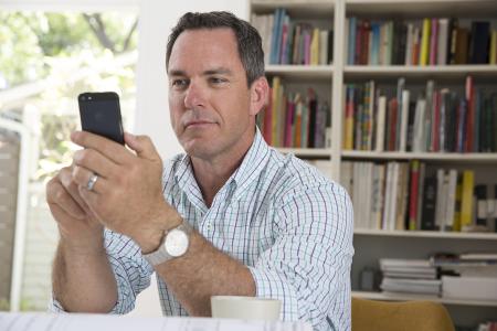 Man on a phone working on a Financing application. 