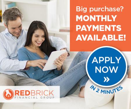 man and woman on couch looking at iPad
